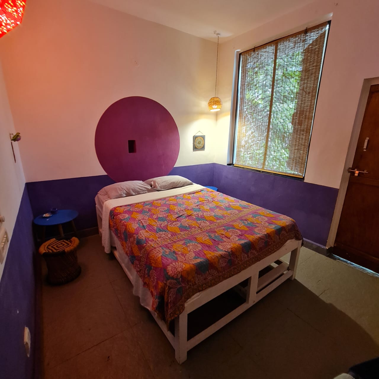 Akash, the violet room, with its double bed and garden-facing window